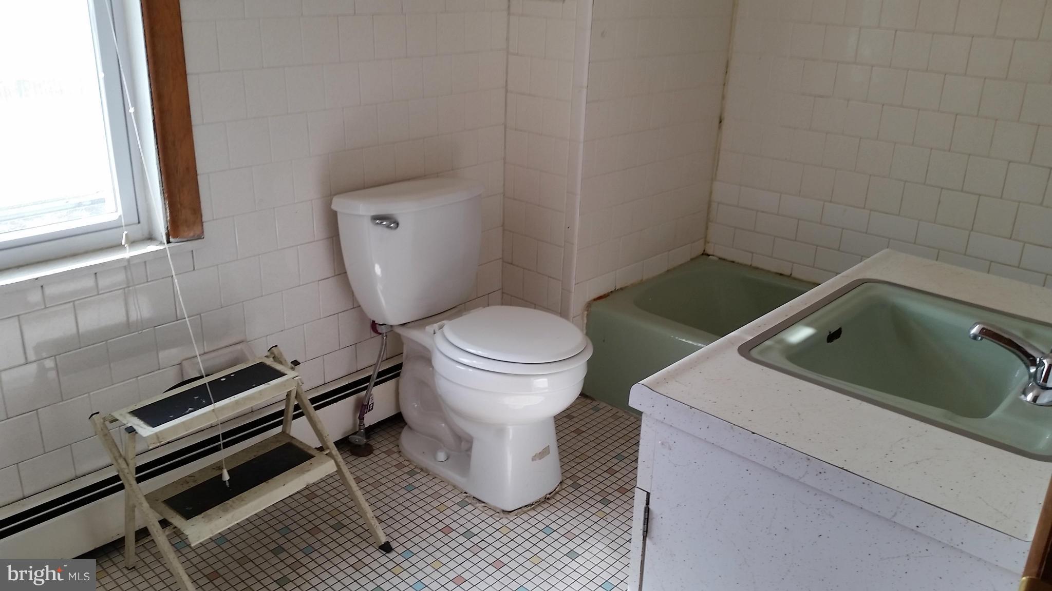 6501 Baltimore Avenue Baltimore, MD 21222 - Photo 5 of 21 a bathroom with a toilet sink and mirror