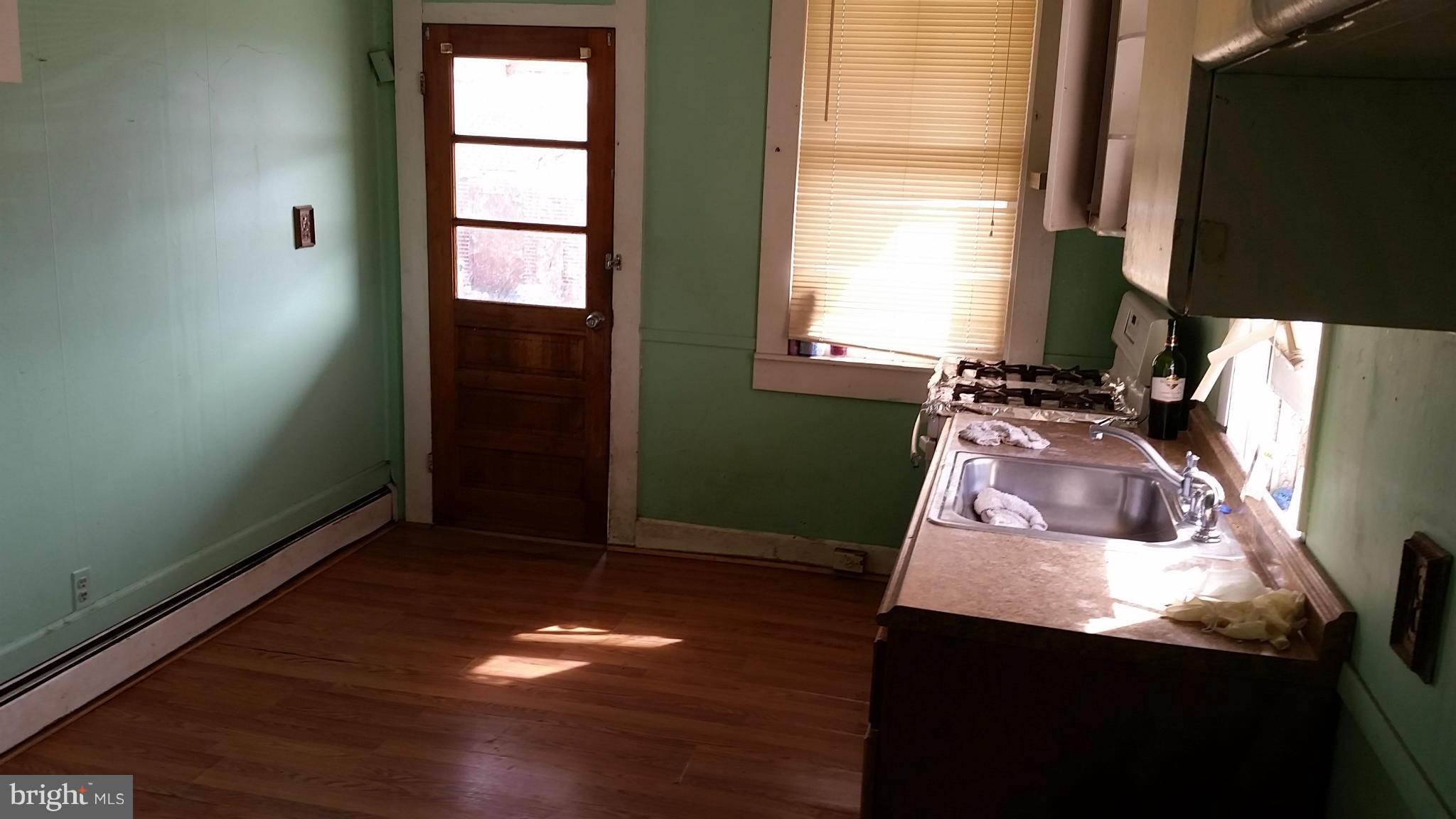 6501 Baltimore Avenue Baltimore, MD 21222 - Photo 7 of 21 a living room with hard wood floors and a window
