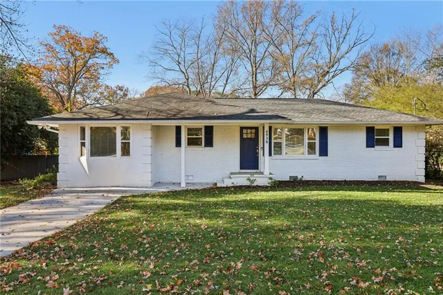 a front view of a house with a garden