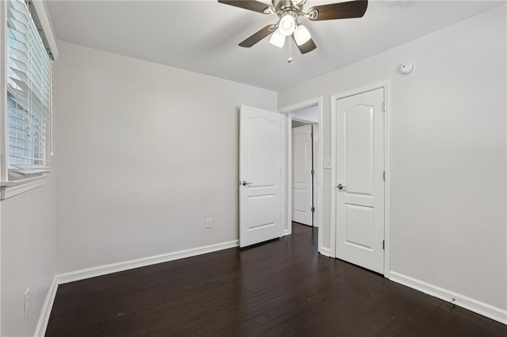 4938 White Boulevard Southwest Mableton, GA 30126 - Photo 25 of 39 an empty room with wooden floor and fan