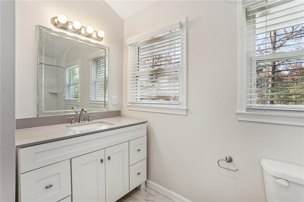 4938 White Boulevard Southwest Mableton, GA 30126 - Photo 27 of 39 a bathroom with a granite countertop sink mirror and a window