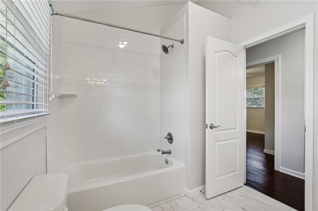 4938 White Boulevard Southwest Mableton, GA 30126 - Photo 28 of 39 a bathroom with a bathtub and a shower