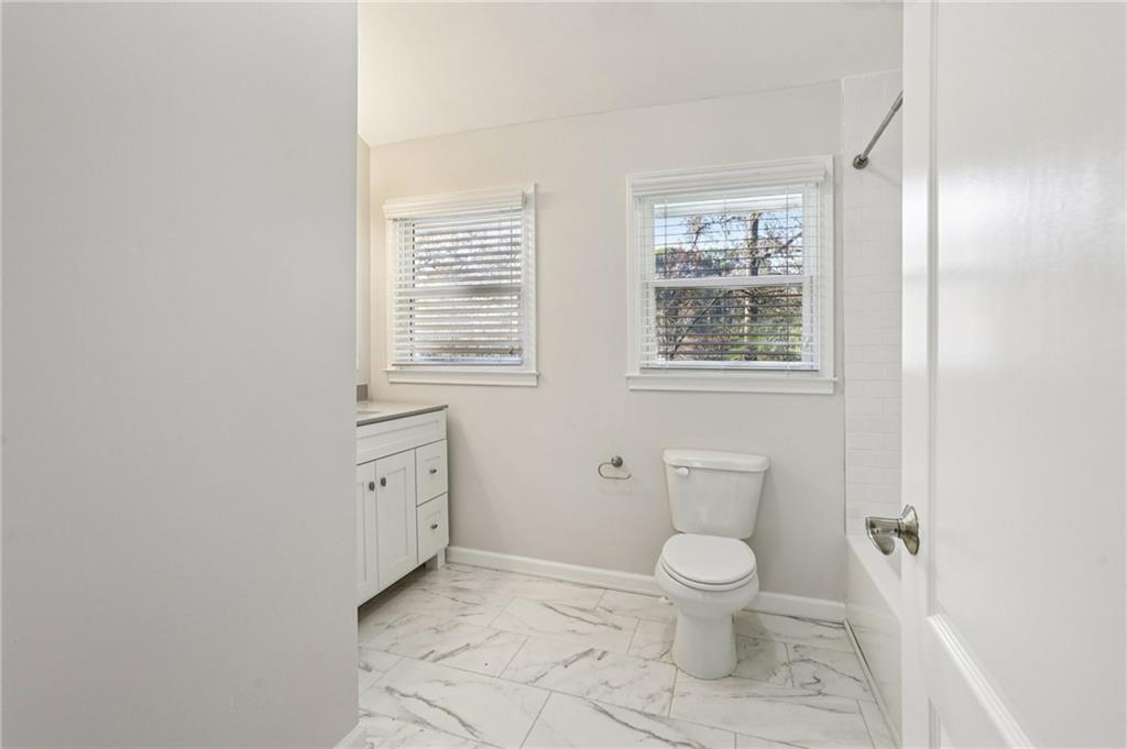 4938 White Boulevard Southwest Mableton, GA 30126 - Photo 29 of 39 a bathroom with a toilet sink a shower and a window