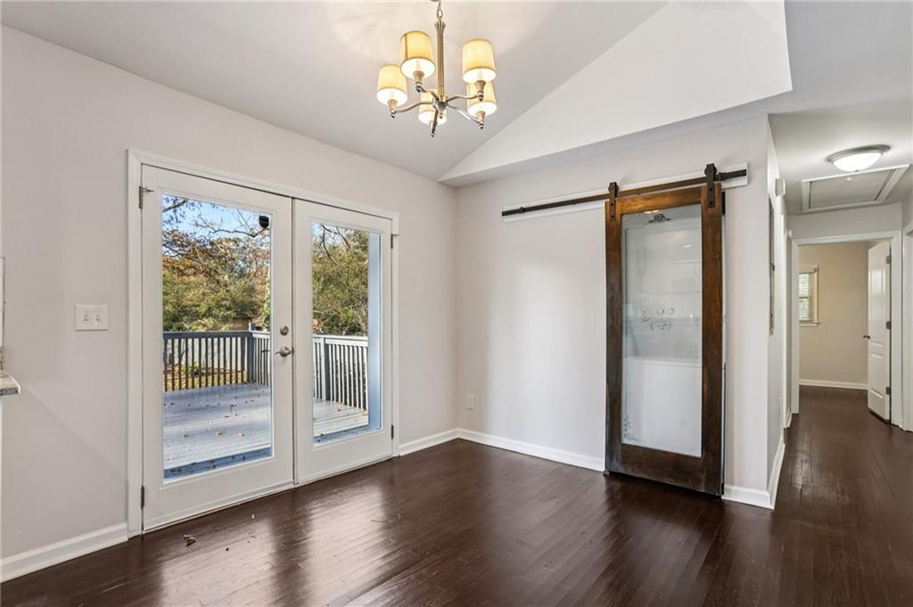 4938 White Boulevard Southwest Mableton, GA 30126 - Photo 9 of 39 a view of a hallway with wooden floor and a chandelier