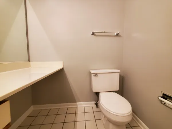 an empty room with a ceiling fan and window