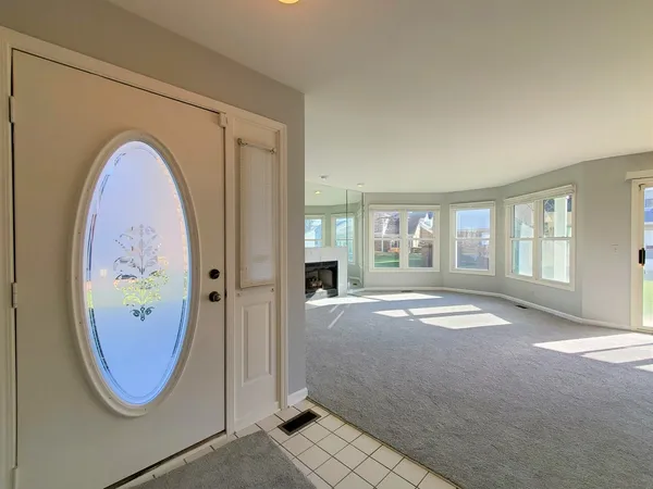 a view of an empty room with a fireplace and a window