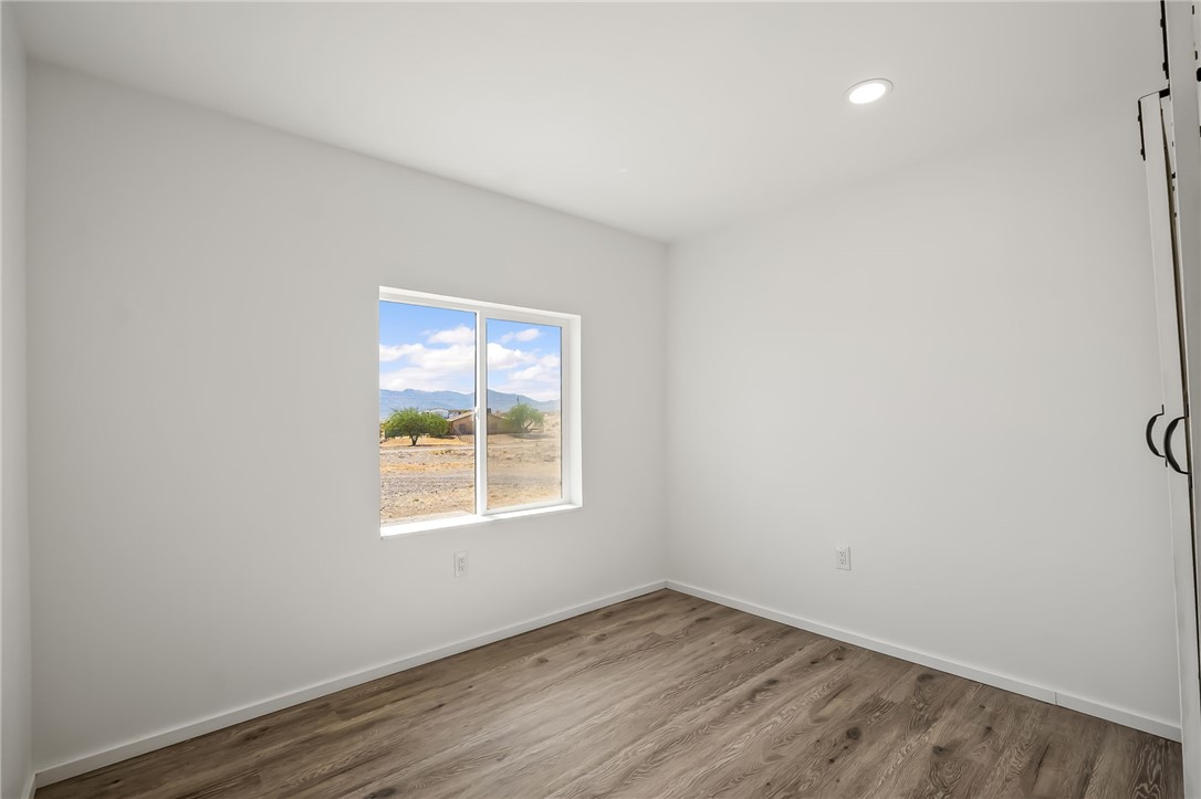 4392 Rio Verde Drive Fort Mohave, AZ 86426 - Photo 11 of 19 Spacious room featuring wood-finish flooring, crisp white walls, and a recessed ceiling light