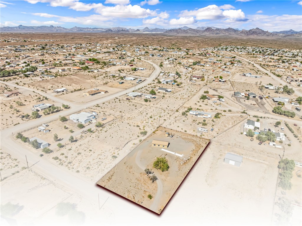 4392 Rio Verde Drive Fort Mohave, AZ 86426 - Photo 4 of 19 Expansive desert lot featuring a single-story structure and mature tree