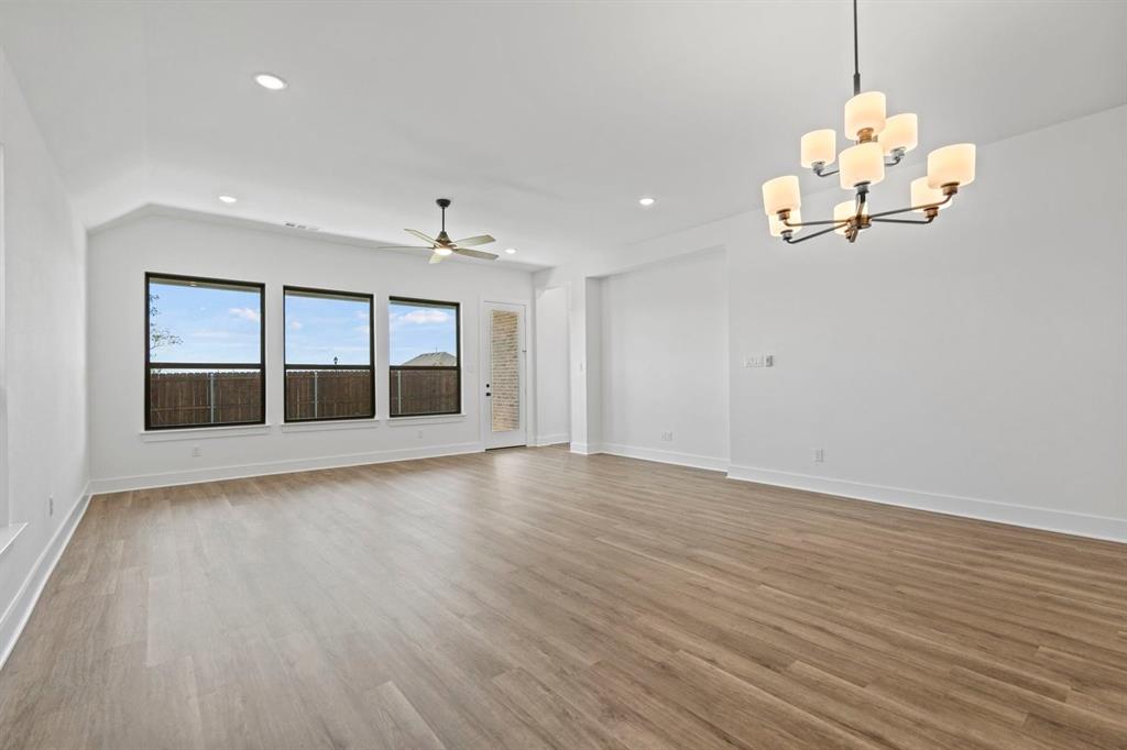 1792 Monarch Way Oak Point, TX 75068 - Photo 12 of 26 a view of an empty room with a window and wooden floor
