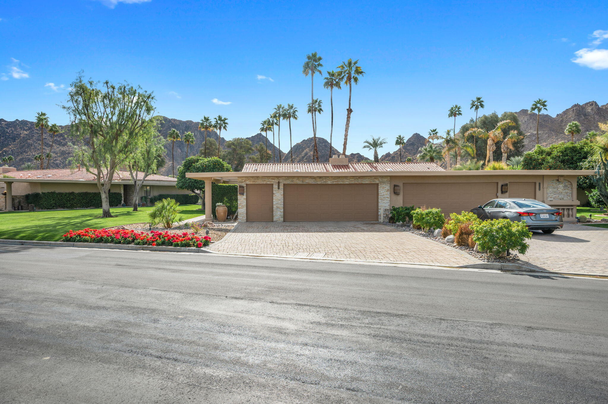 77675 Seminole Road Indian Wells, CA 92210 - Photo 39 of 40 a front view of a house with a yard and a garage
