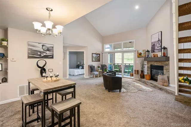 a living room with furniture a fireplace and a chandelier