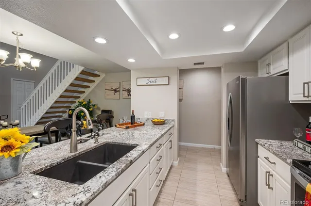 a kitchen with a sink stove and refrigerator