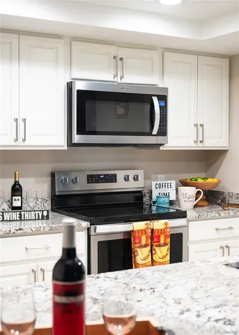 a kitchen with stainless steel appliances kitchen island granite countertop a stove and a sink