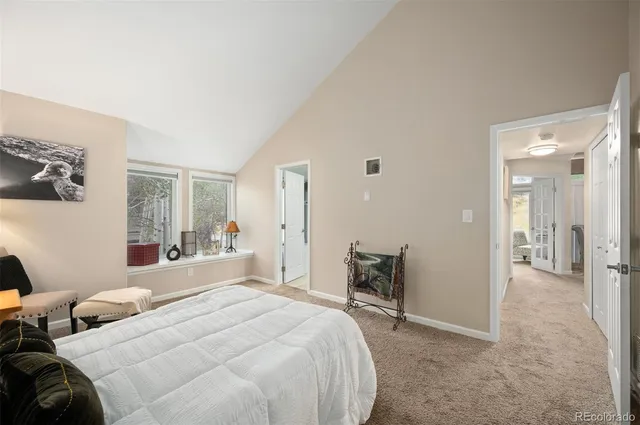 a bedroom with a bed and a mirror