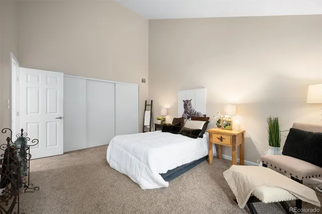 a bedroom with a bed and a couch