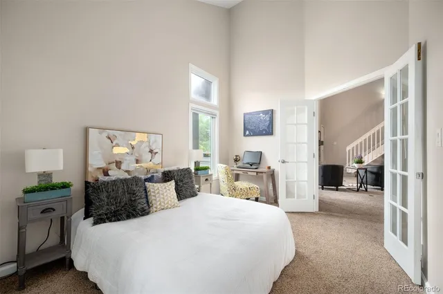 a bedroom with a large bed and a chandelier