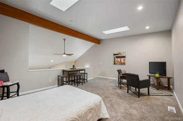 a bedroom with a bed a table and chair