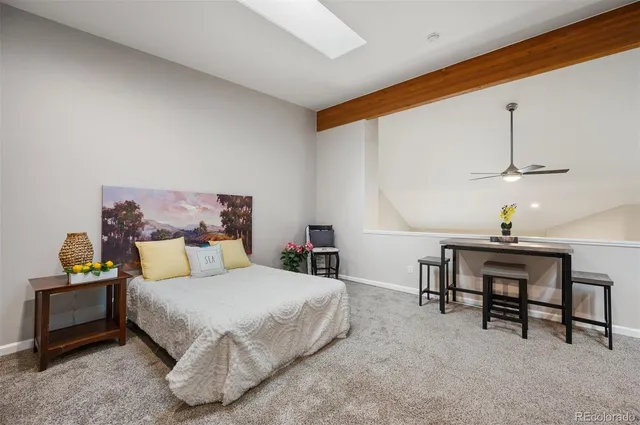 a bathroom with a granite countertop toilet sink and mirror