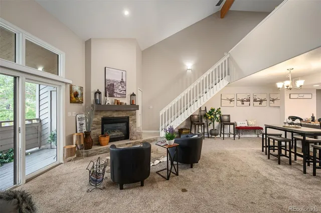 a living room with lots of furniture and a fireplace