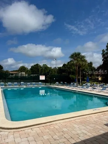 a view of a swimming pool with a yard