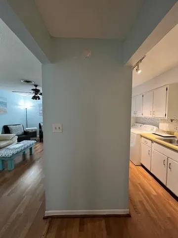 a kitchen with a refrigerator and a stove top oven