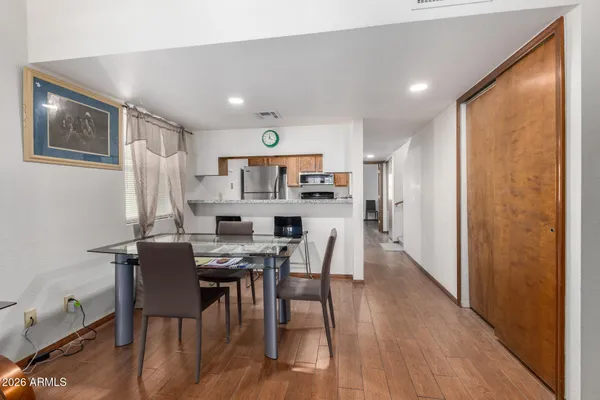a view of a dining room with furniture and wooden floor