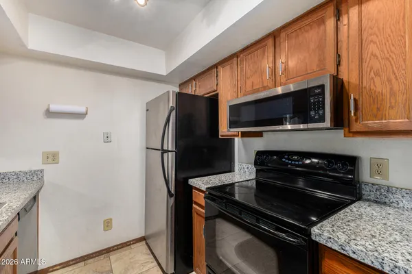 a kitchen with a refrigerator stove and microwave