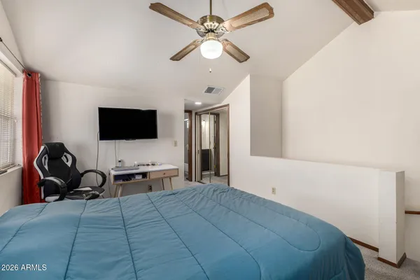 a room with a bed and a flat screen tv