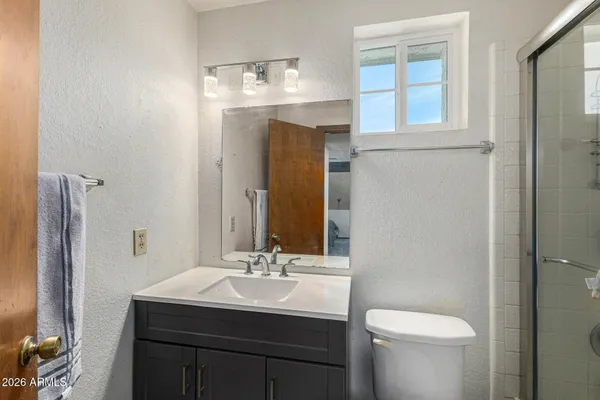 a bathroom with a toilet sink and mirror