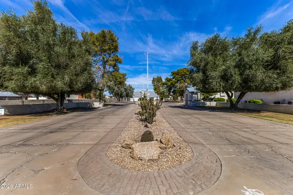 a view of a patio with table and chairs with wooden fence