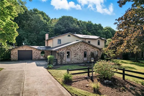 a front view of a house with a garden and sitting area