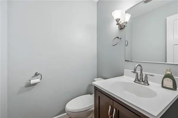a bathroom with a sink a toilet and mirror