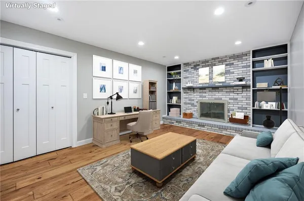 a living room with furniture and a fireplace