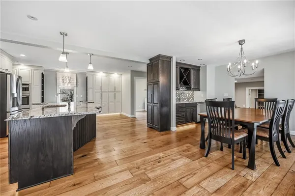 a view of a dining room with furniture and chandelier