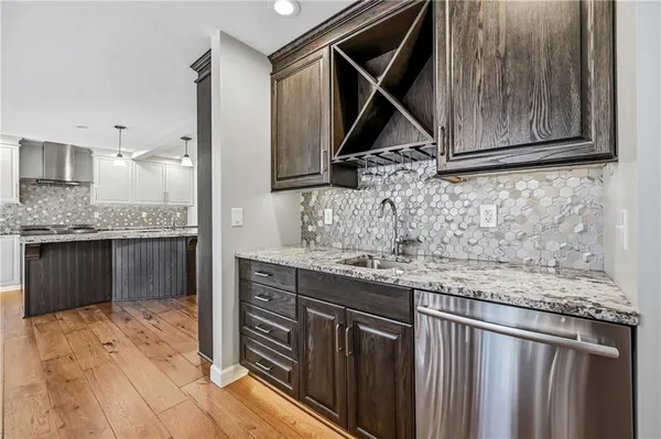a kitchen with kitchen island granite countertop a sink and cabinets