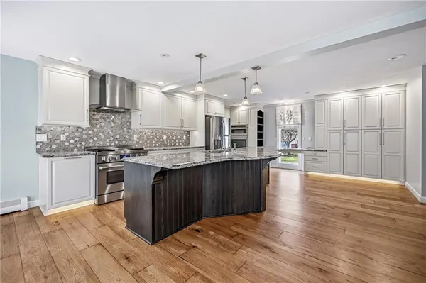 a kitchen with granite countertop a stove and cabinets