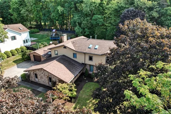an aerial view of a house with yard swimming pool and outdoor seating