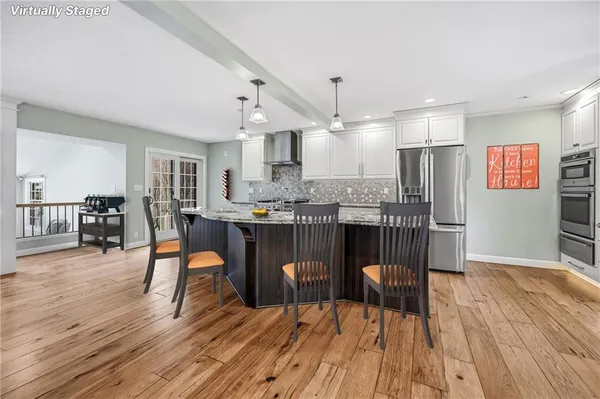 a dining room with furniture and wooden floor