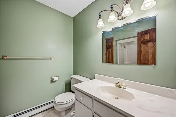 a bathroom with a sink a toilet and mirror