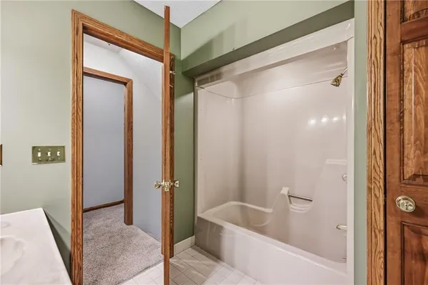 a bathroom with a tub and shower