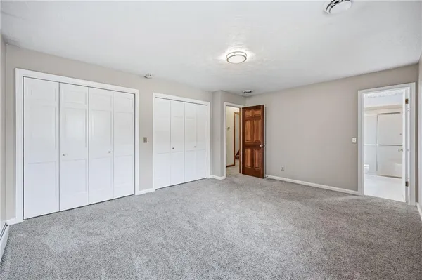 a view of an empty room and closet area