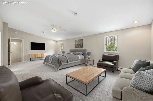a living room with furniture flat screen tv and a window
