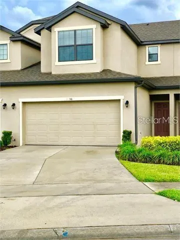 a front view of a house with garage