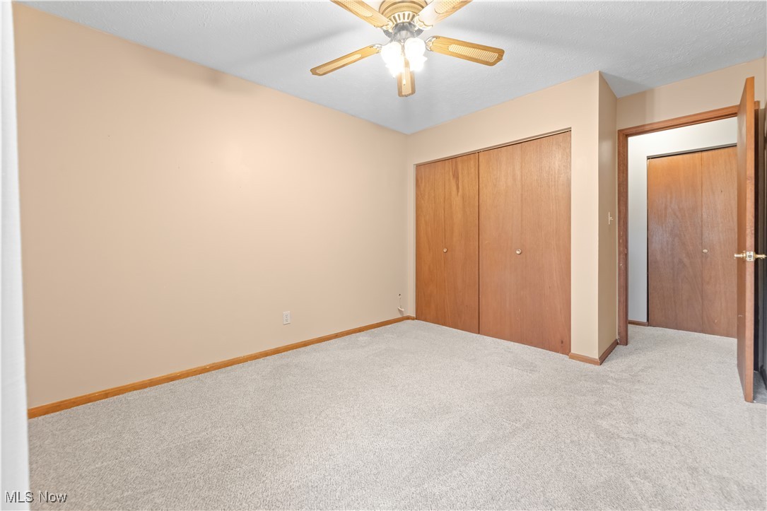 1574 Faye Road Akron, OH 44306 - Photo 16 of 45 Unfurnished bedroom with a closet, ceiling fan, and light colored carpet