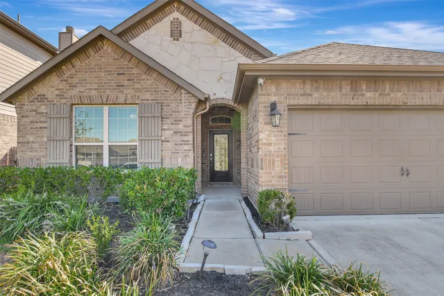 a view of a brick house with potted plants