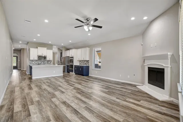 a view of kitchen with refrigerator oven and microwave