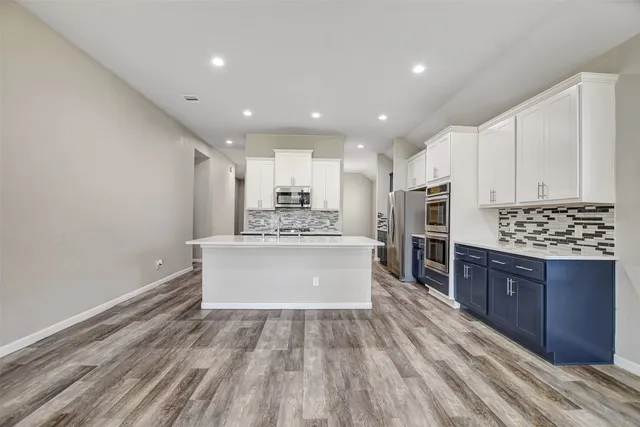 a view of a kitchen with a stove cabinets and a ceiling fan