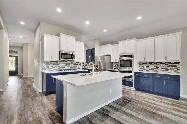 a kitchen with a sink stainless steel appliances and cabinets