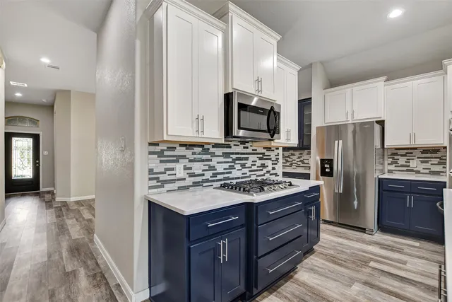 a kitchen with stainless steel appliances a sink stove and refrigerator
