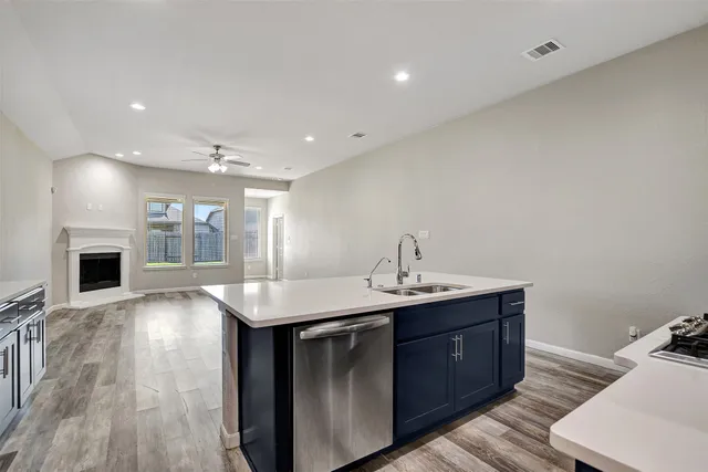a view of a kitchen with a sink and refrigerator